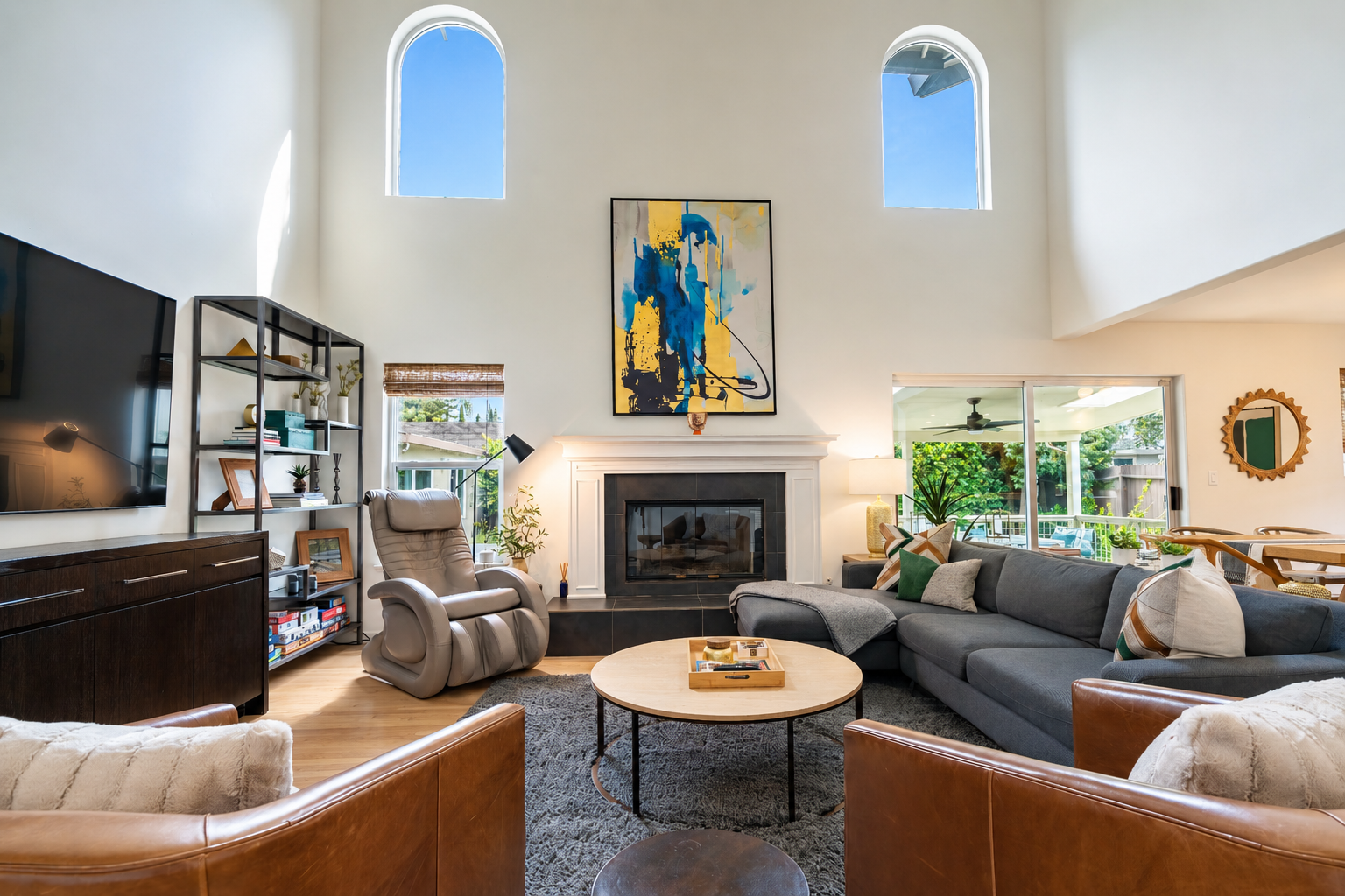 Living area with smart tv, massage chair and fireplace.