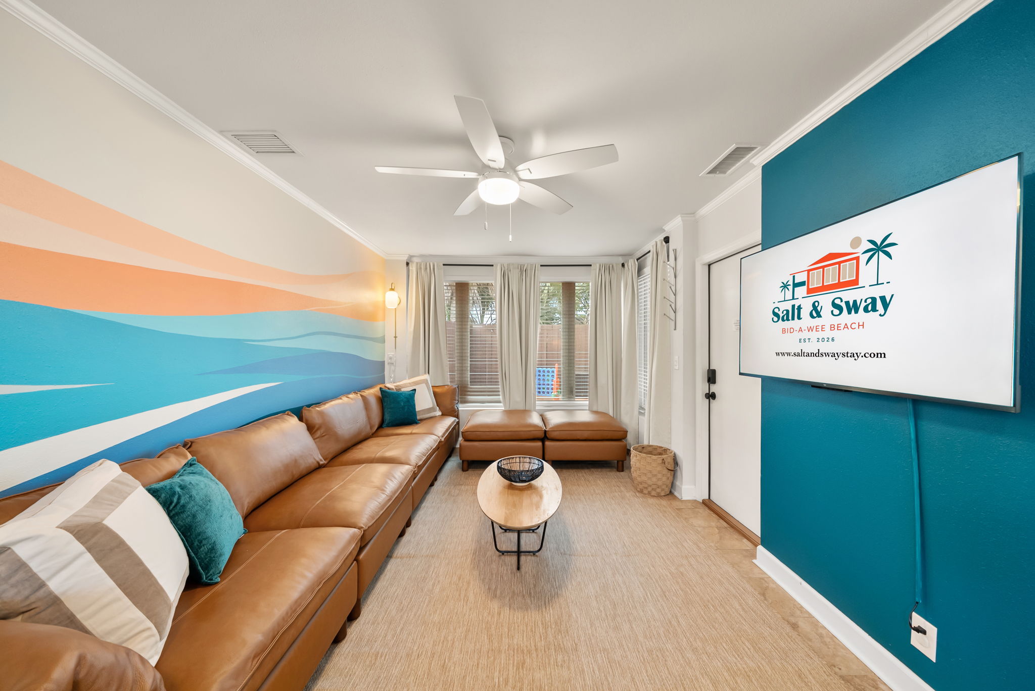 Gather the whole crew in the open living room under the
hand-painted surf-wave mural. The oversized sectional fits everyone for movie nights, game streaming, or just unwinding after the
beach.