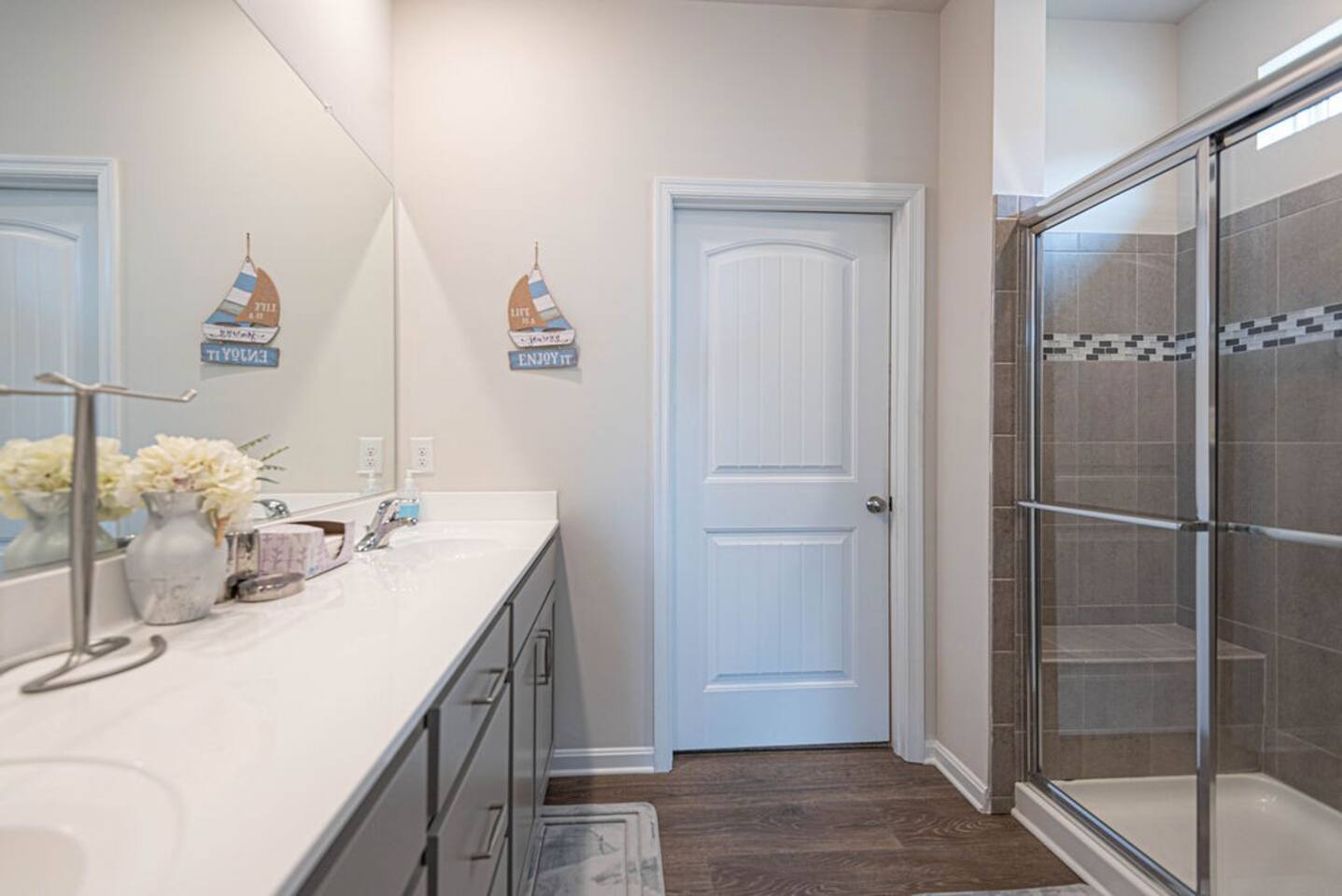 Welcome to the ensuite oasis! A spacious walk-in shower invites relaxation, complemented by a practical double vanity. A private toilet area adds a touch of privacy, completing this tranquil and functional bathroom retreat.