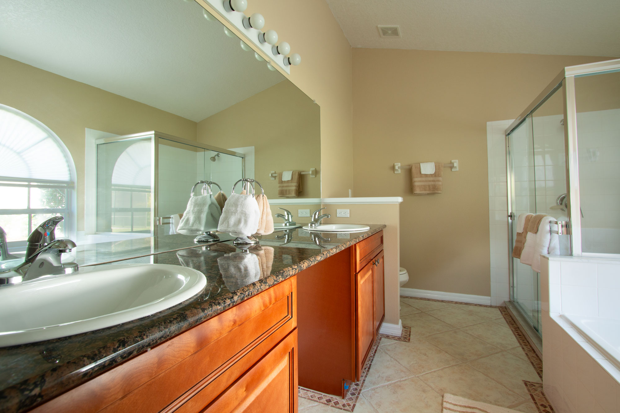 Master Bath with dual vanity, large glass shower and soaking tub.