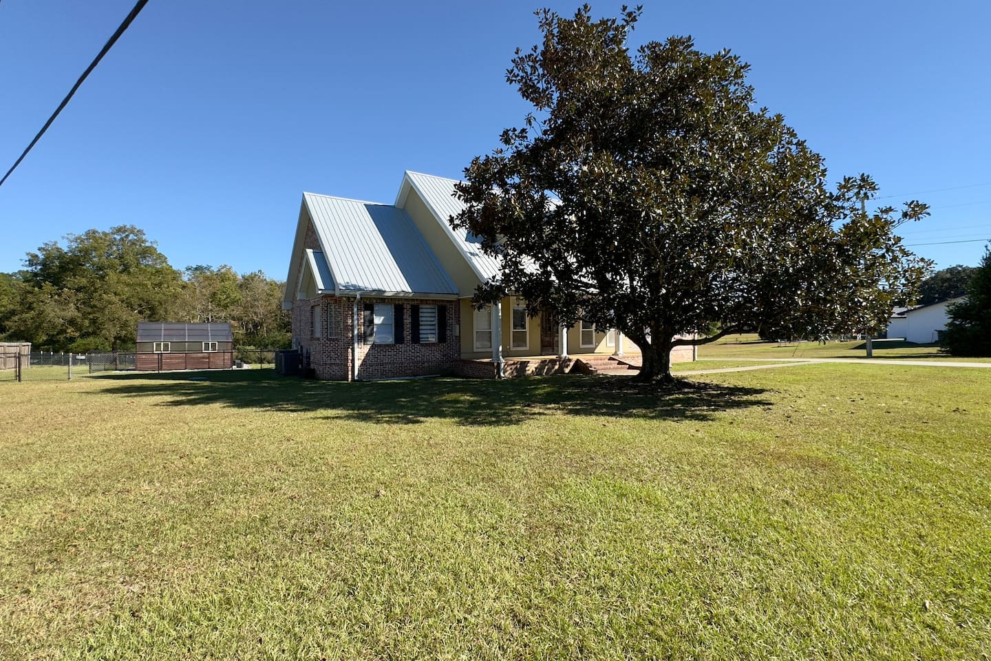 A wide grassy lawn surrounds the property, perfect for outdoor play or relaxation.
