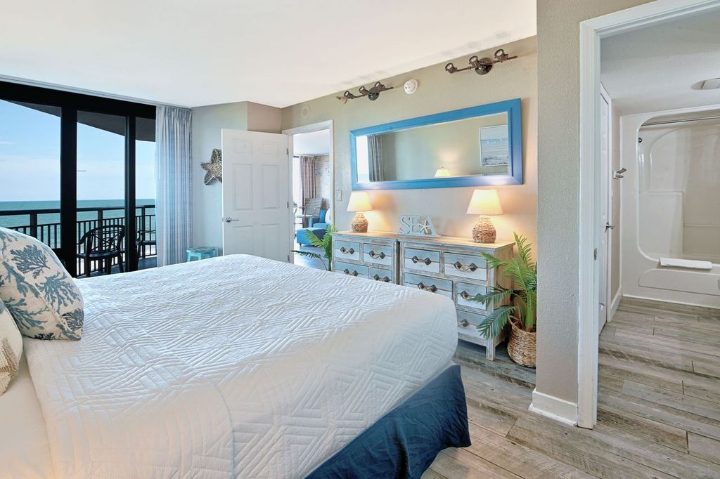 Rest up after a day in the sun in this plush, coastal-themed master suite.