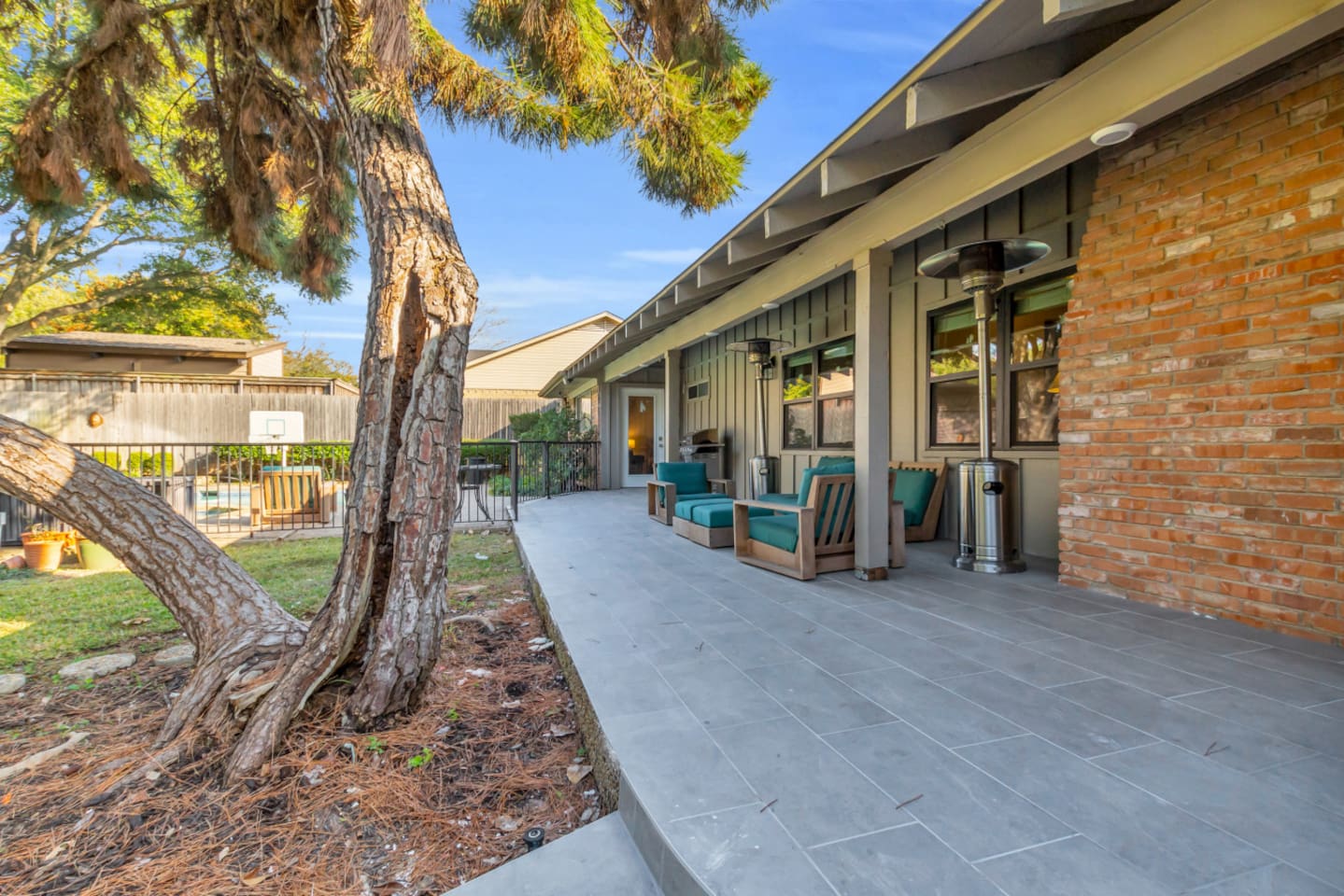 Spacious private backyard with comfortable outdoor seating and propane heaters, perfect for relaxing evenings, social gatherings, and enjoying the outdoors year-round.