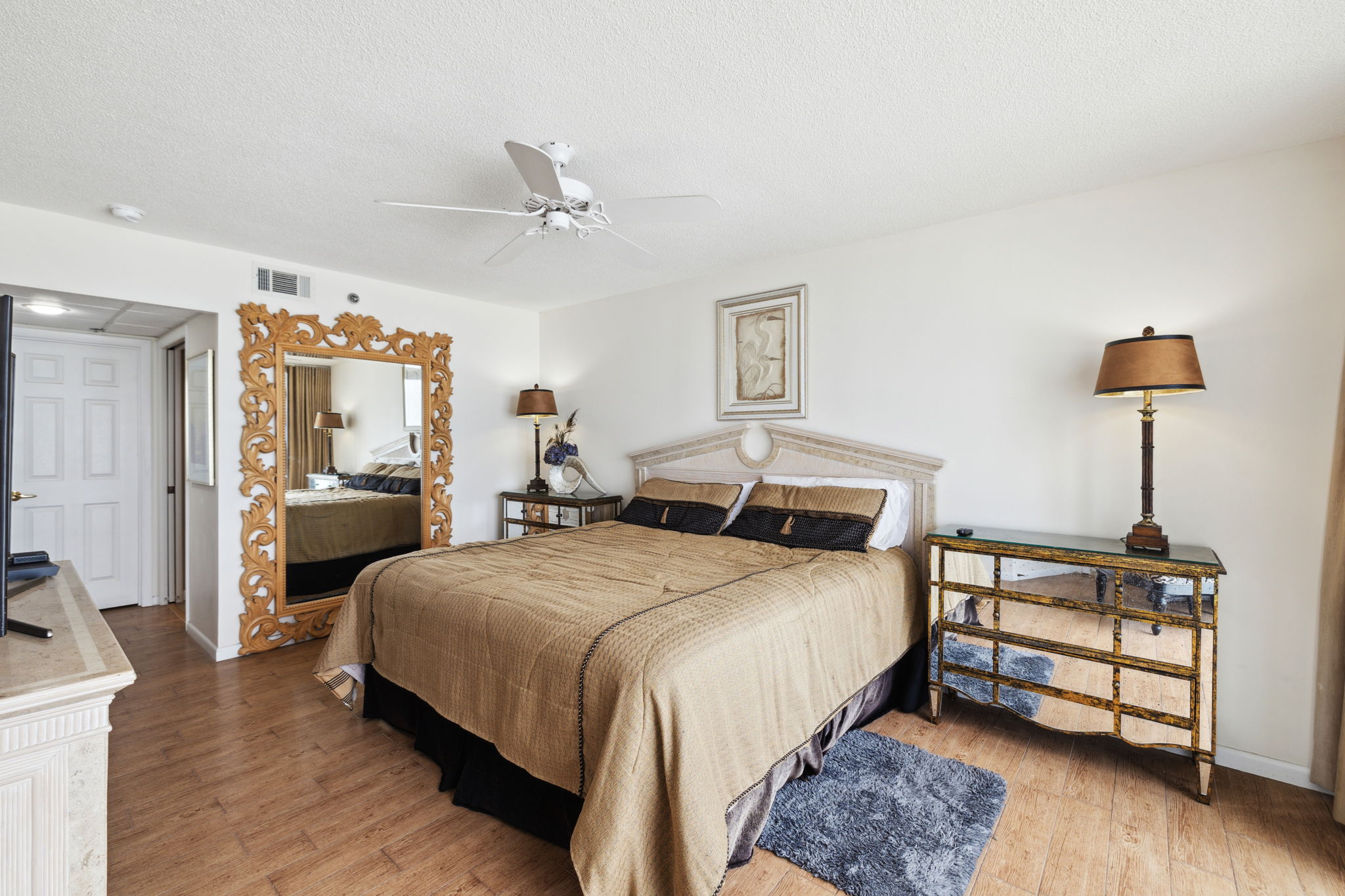 Master king suite bedroom with floor to ceiling windows showcasing the beautiful Emerald Gulf waters, balcony access from bedroom and en suite bathroom