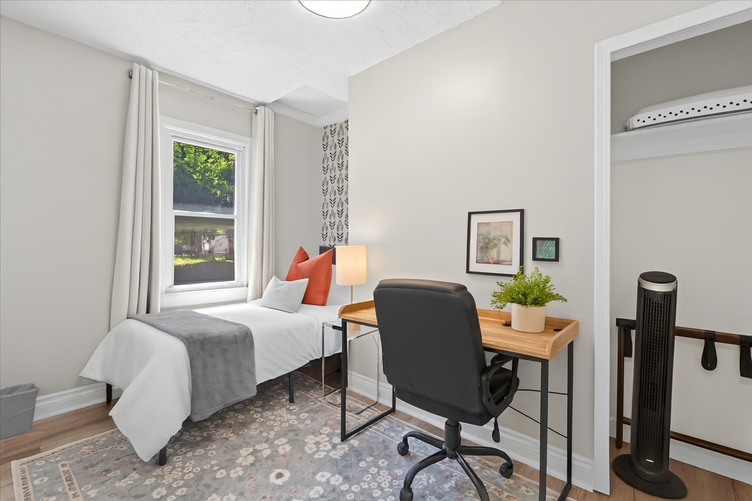 Cozy bedroom with twin bed and functional desk