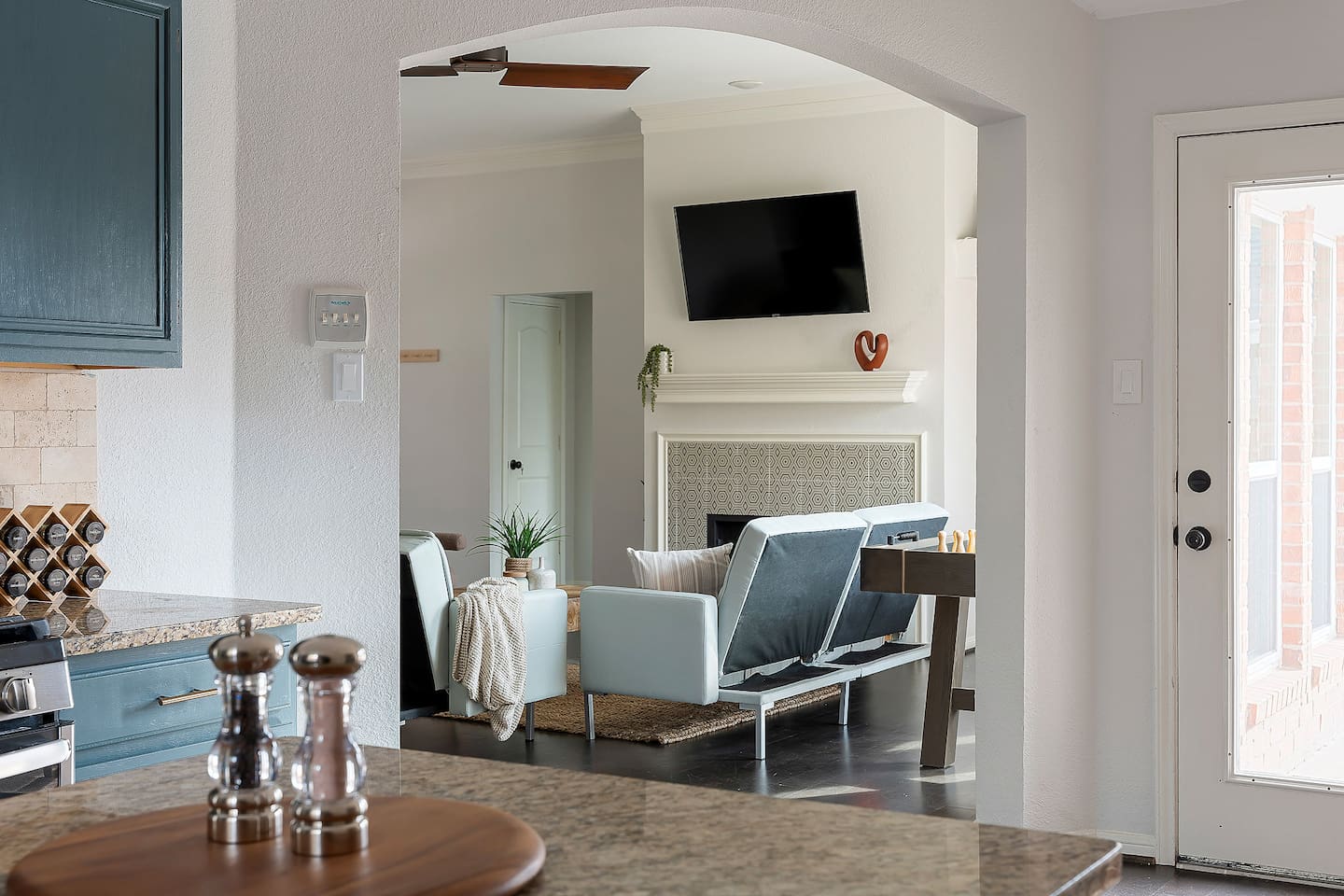 Welcome to our inviting living space with cozy sofas and a sleek TV setup. Shaded windows bring in just the right amount of natural light, creating a perfect balance of comfort and ambiance.