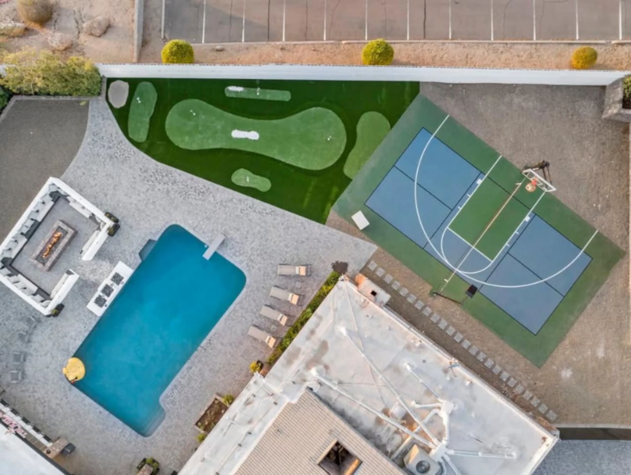 From above: pool, putting green, and sport court all connect in one backyard layout.