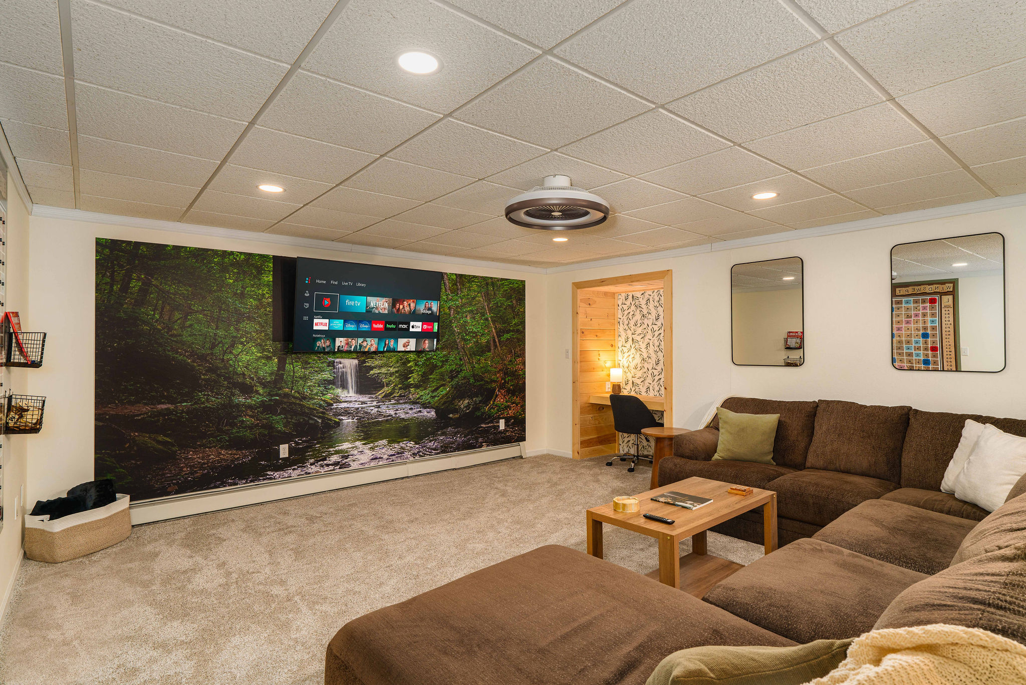 Spacious Lower Living Room with 65" HDTV & Oversized Sectional. Movie nights, relaxation, and comfort for the whole group.