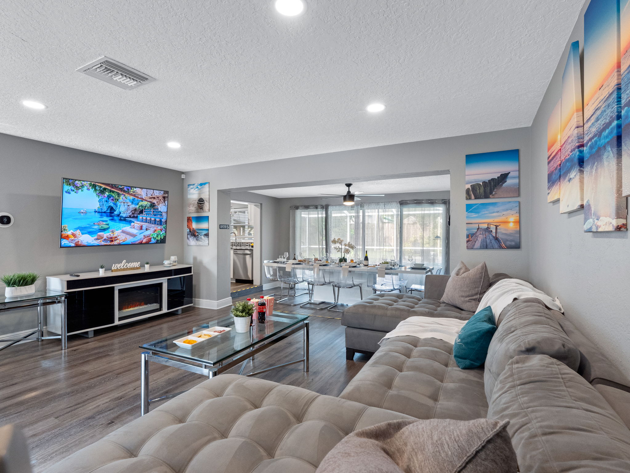 With its oversized sectional, calming coastal artwork, and a massage chair tucked in the corner, this living room is built for serious relaxation.