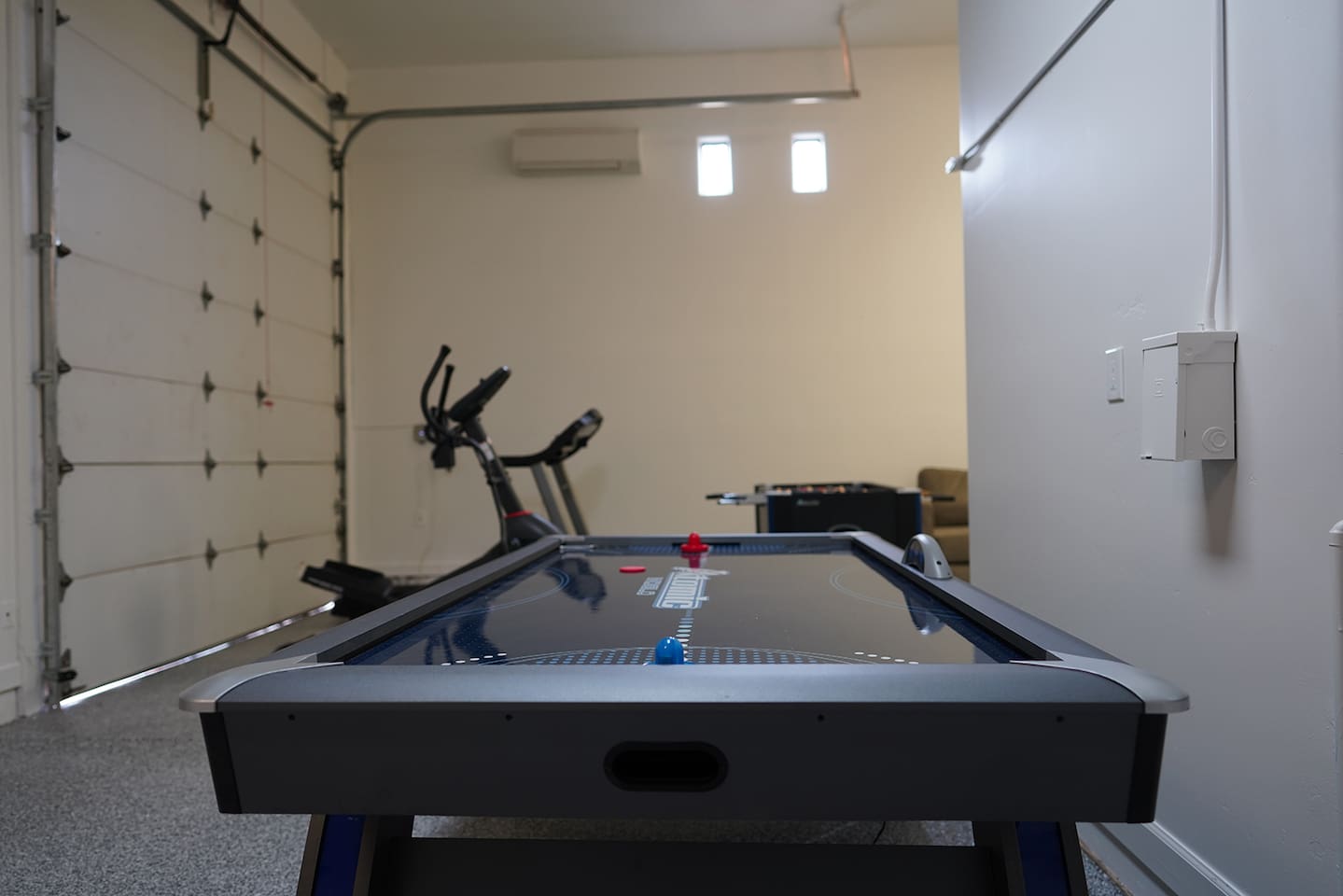 Air conditioned and heated garage space includes tons of games like foosball, air hockey, and shuffleboard.