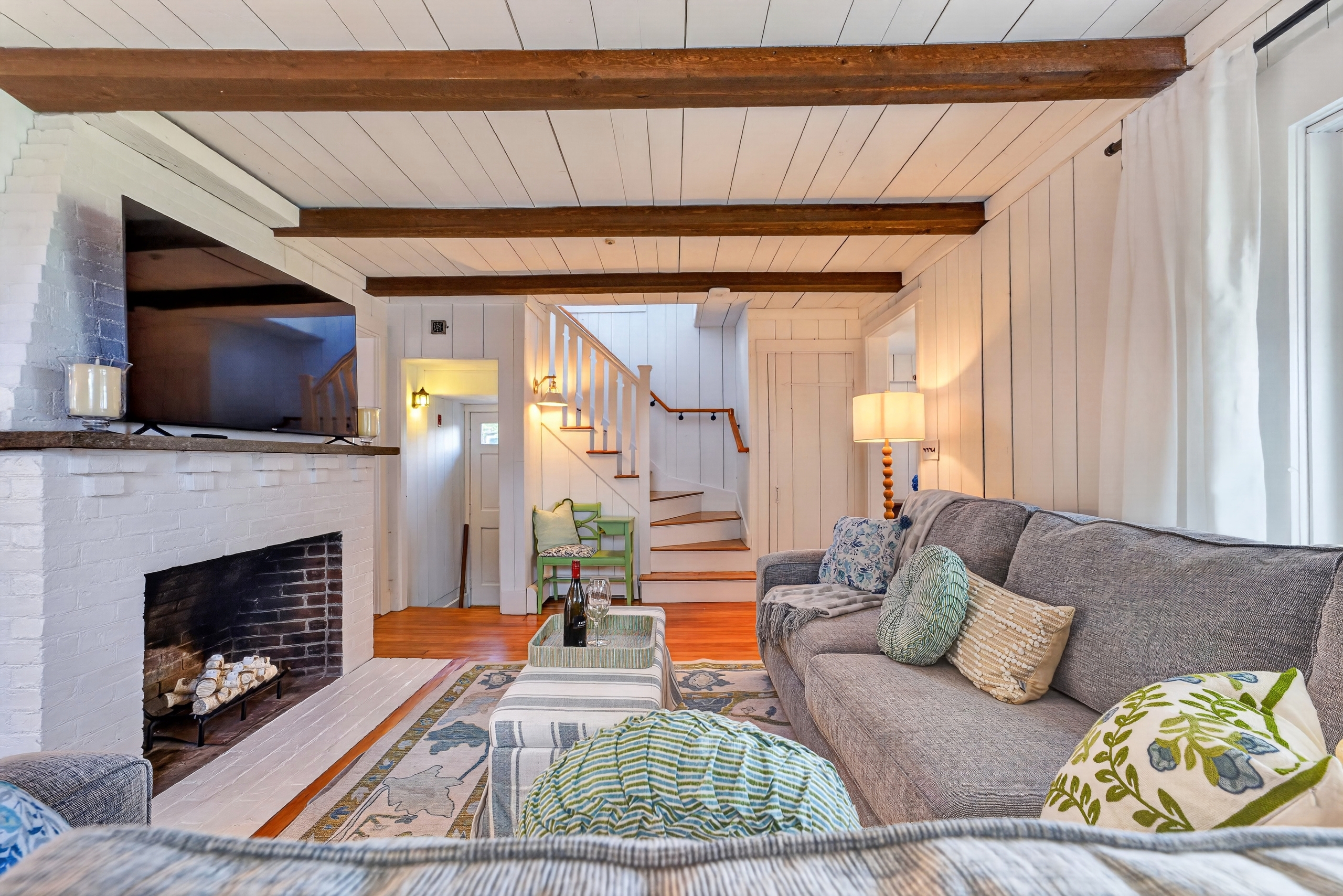 Cozy living room featuring a TV and fireplace, creating a warm and comfortable space for relaxing or movie nights.