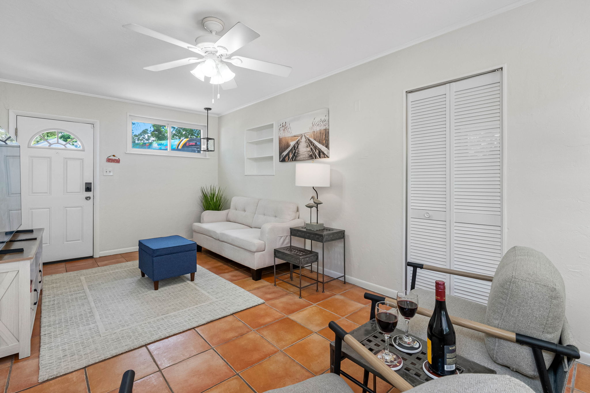 With its coastal artwork, warm flooring, and crisp white walls, this secondary living space perfectly blends comfort and style—ideal for morning coffee or evening chats.
