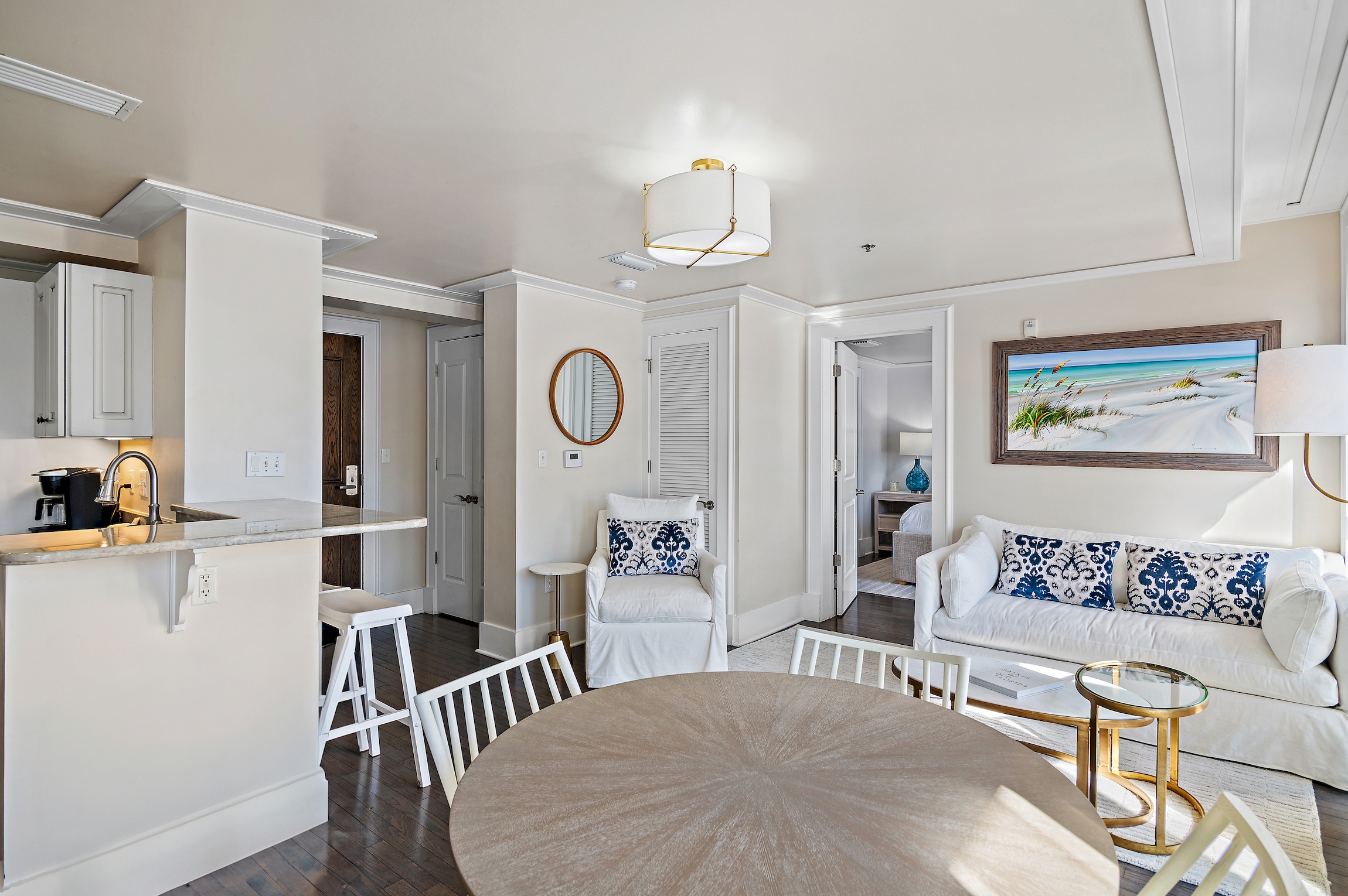 Beautifully furnished living room boasts a slipcovered sofa and matching armchair.