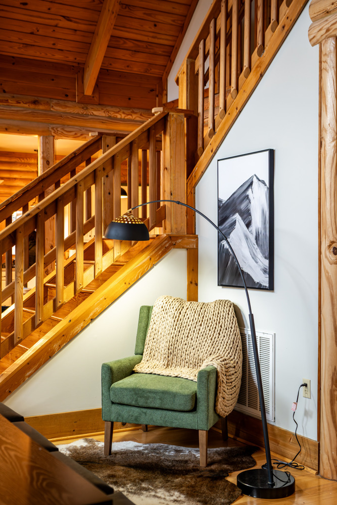 Cozy reading nook tucked under the stairs.