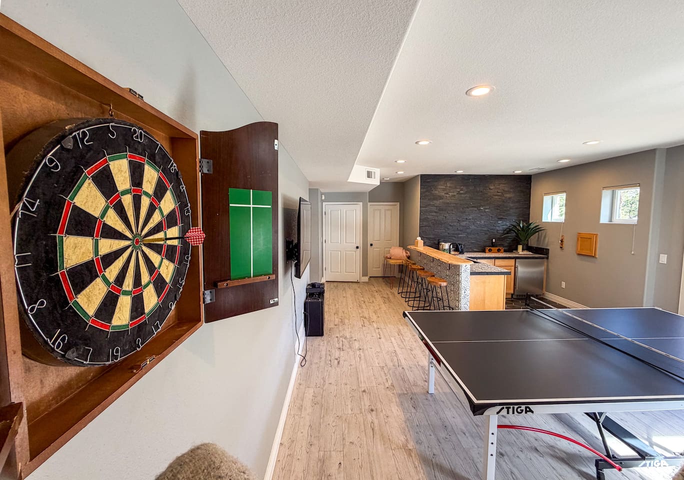 Spacious entertainment room with ping pong, darts, and a stylish bar area—perfect for game nights and group gatherings.