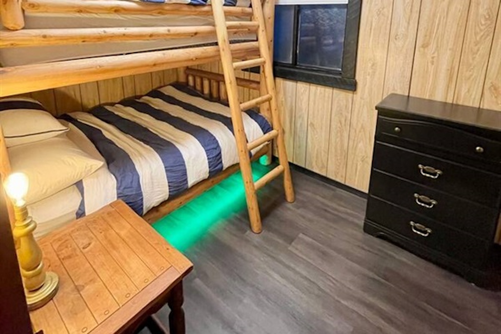 Bunk room with storage and warm wood-paneled interior