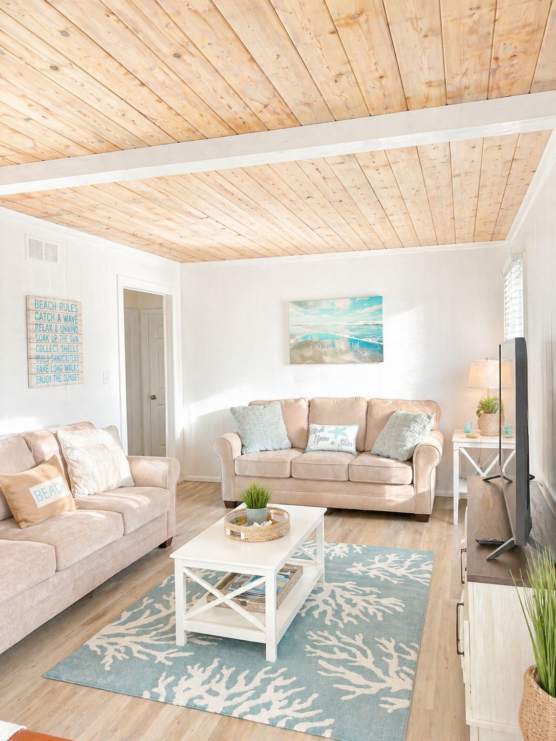 A cozy living room featuring a large smart TV, a collection of books, and plenty of games.