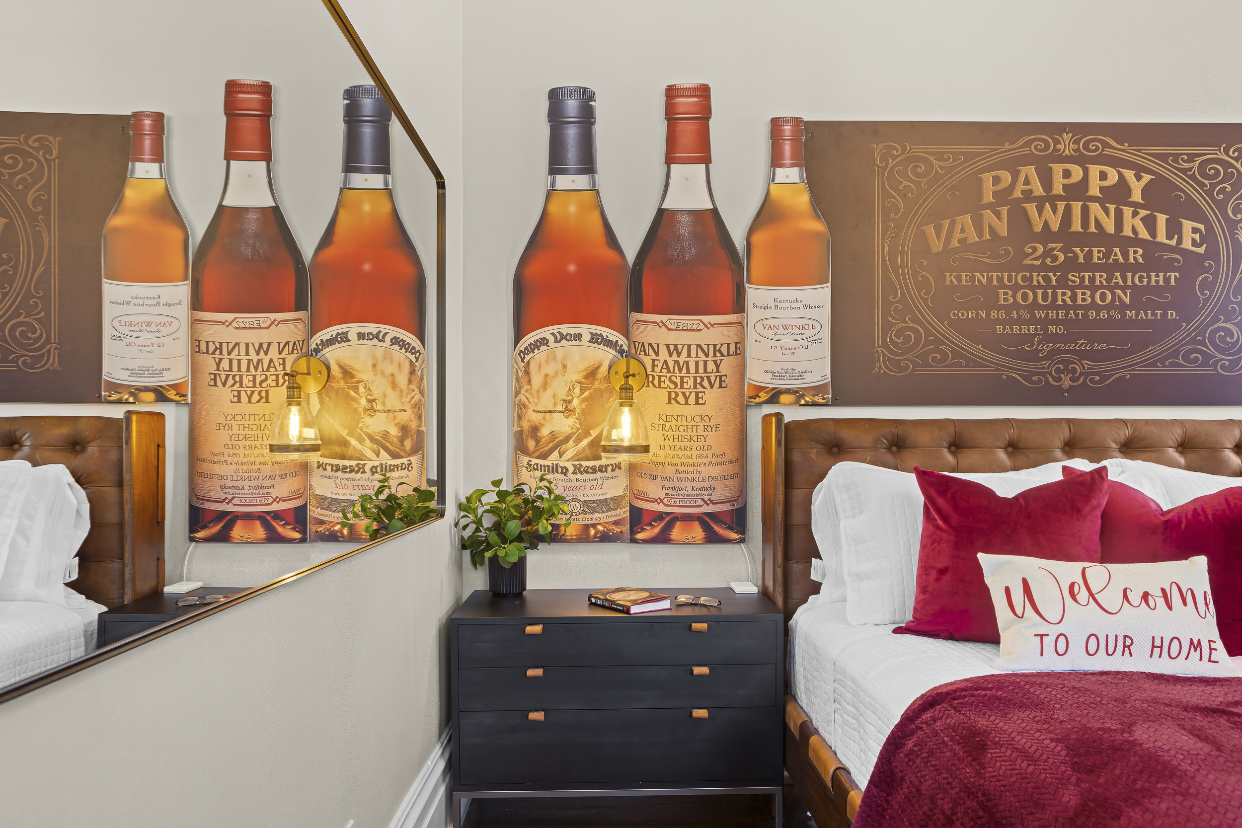 A tufted leather headboard framed by Van Winkle Reserve murals makes the Pappy Room a standout tribute to Kentucky’s bourbon heritage.