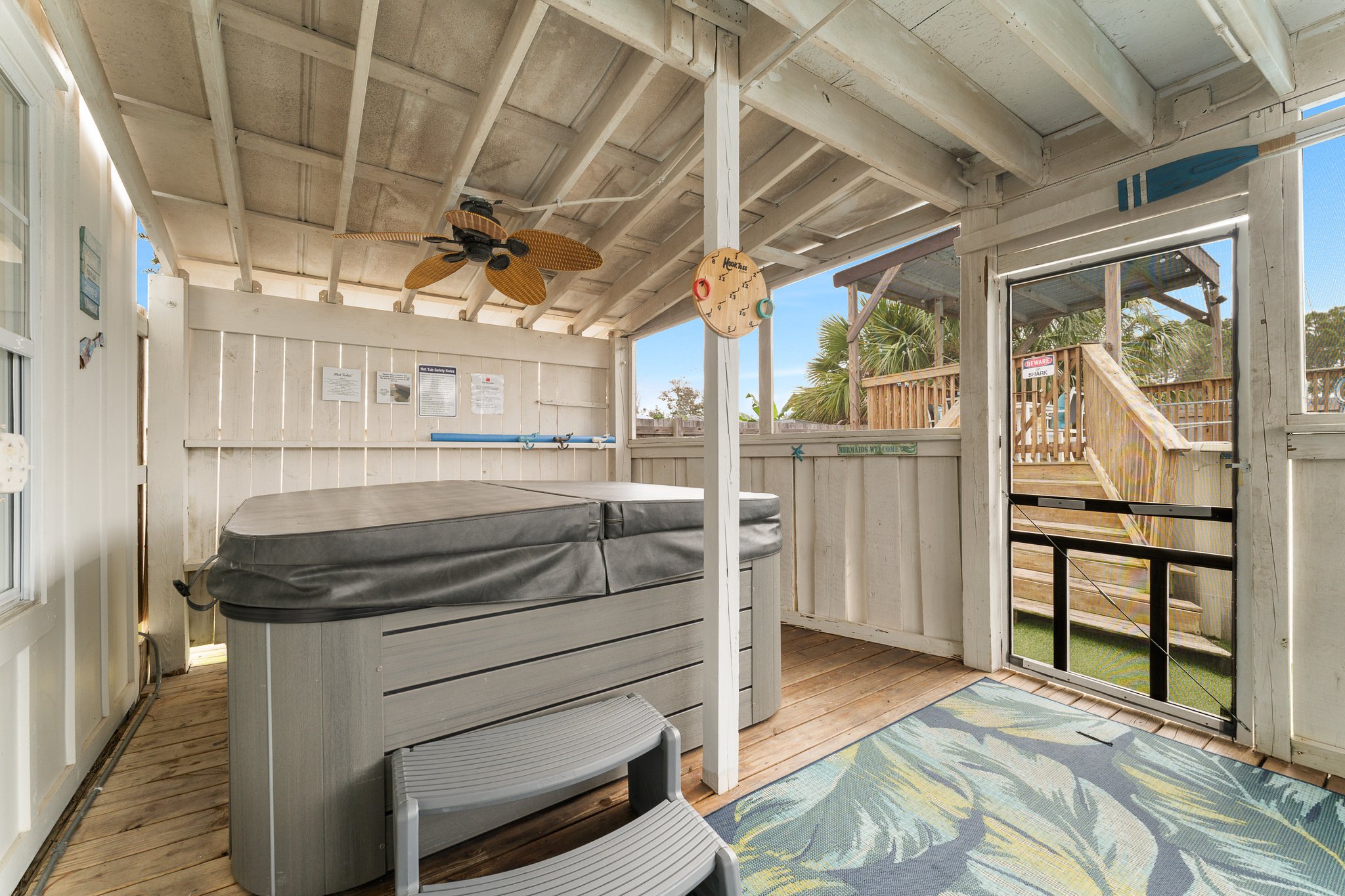 Covered hot tub, dartboard, sunroom interior