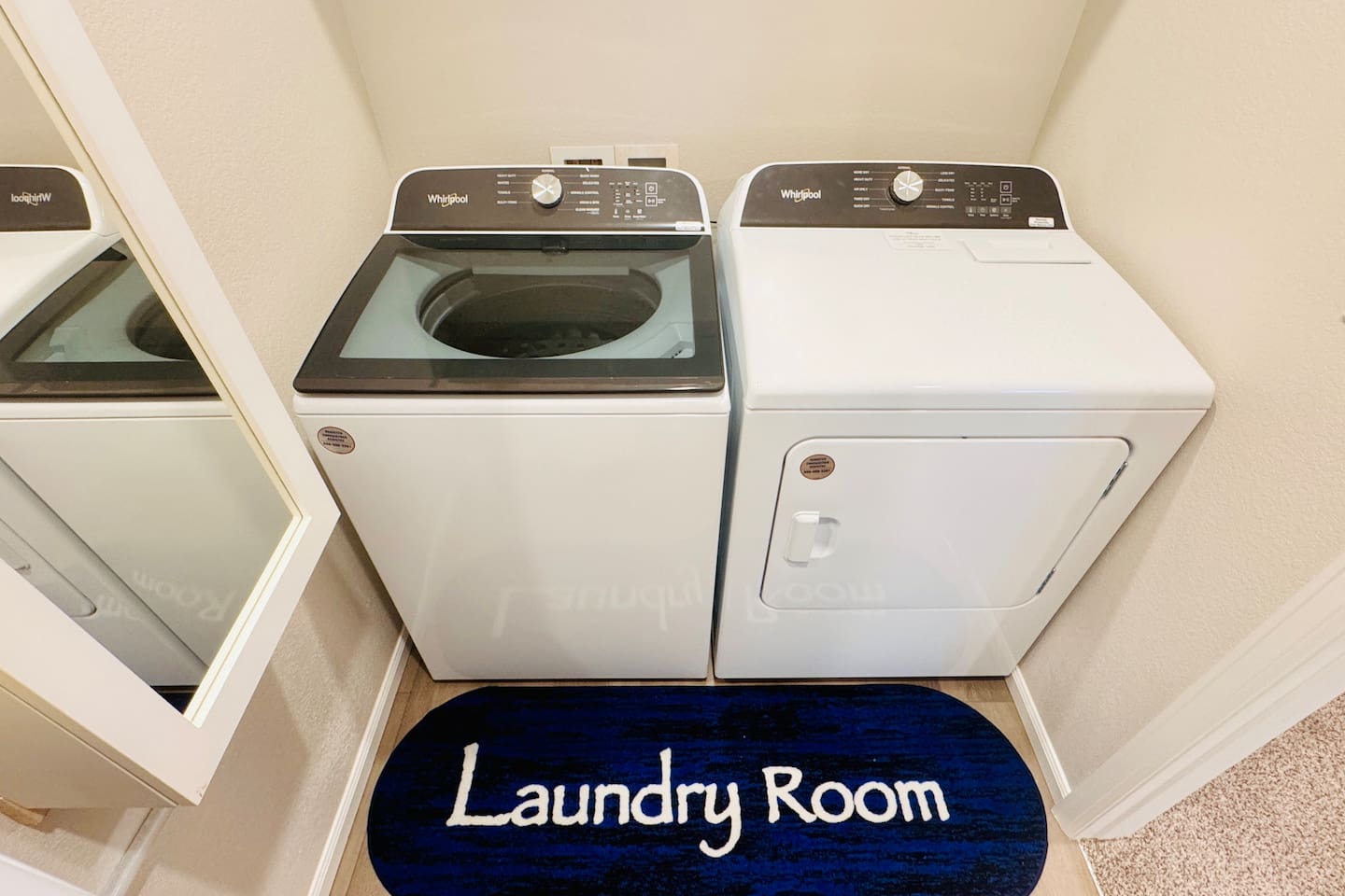 A laundry room equipped with an ironing table, iron box, and a full-length mirror for added convenience.






