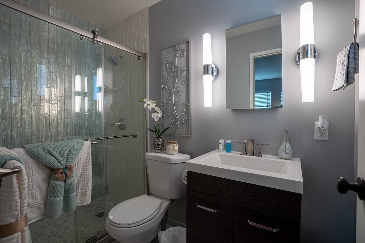 A bathroom with a sink, toilet, and shower, ready for a day of adventure.