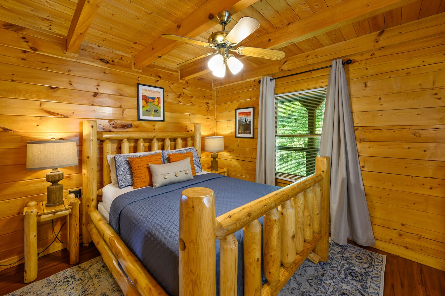 Main floor bedroom with queen size bed, dresser, 43" smart tv and closet. 