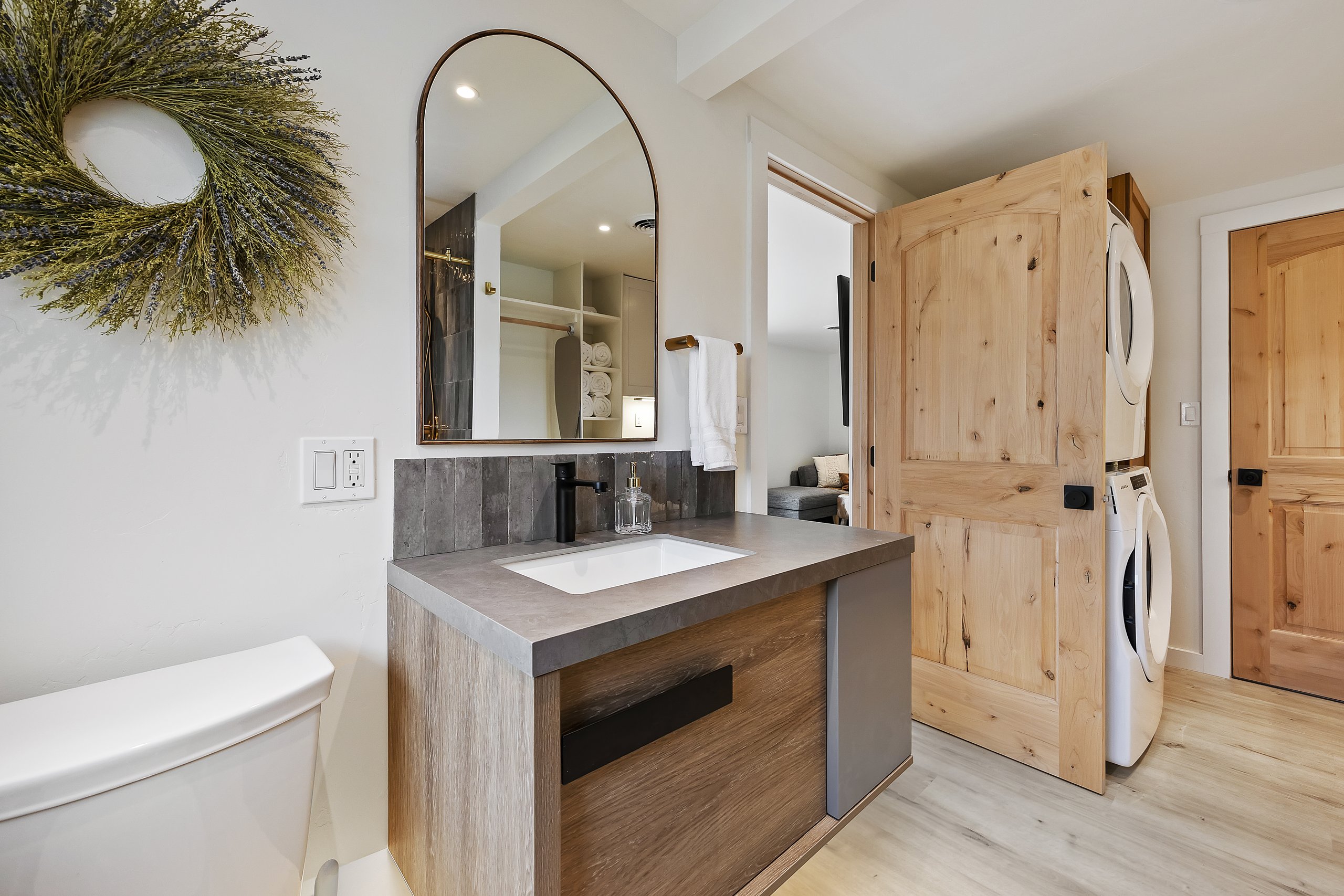 Bath vanity with an in-unit stacked washer and dryer