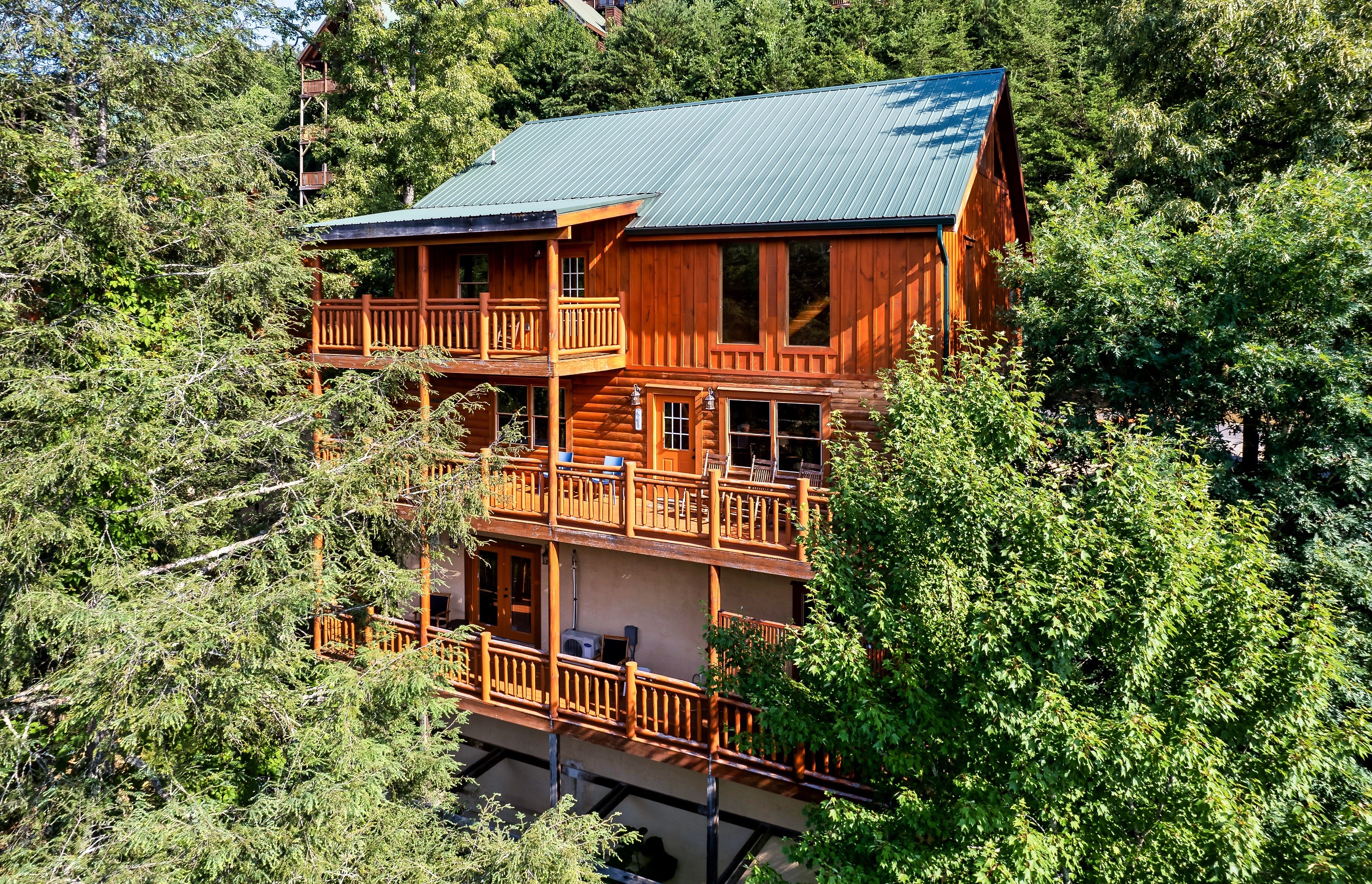 Step back and admire this stunning three story cabin wrapped in trees and views, designed for unforgettable group escapes.