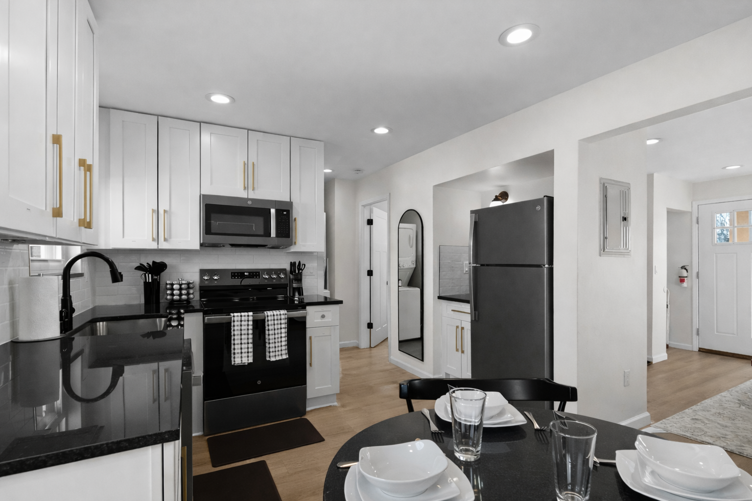 Sleek, modern kitchen with crisp white cabinetry, stainless appliances, and ample counter space—perfect for cooking, hosting, and everyday convenience.