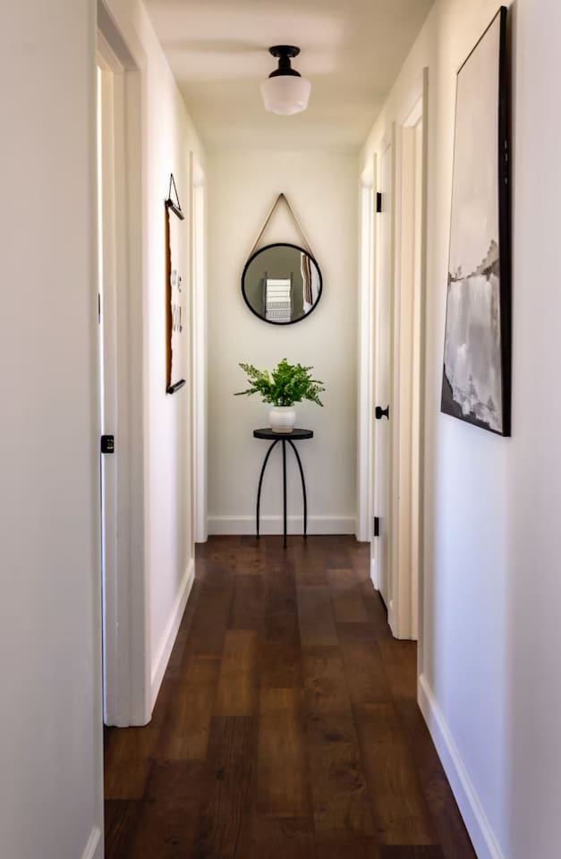 A quiet, styled hallway sets the tone the moment you step through the door.