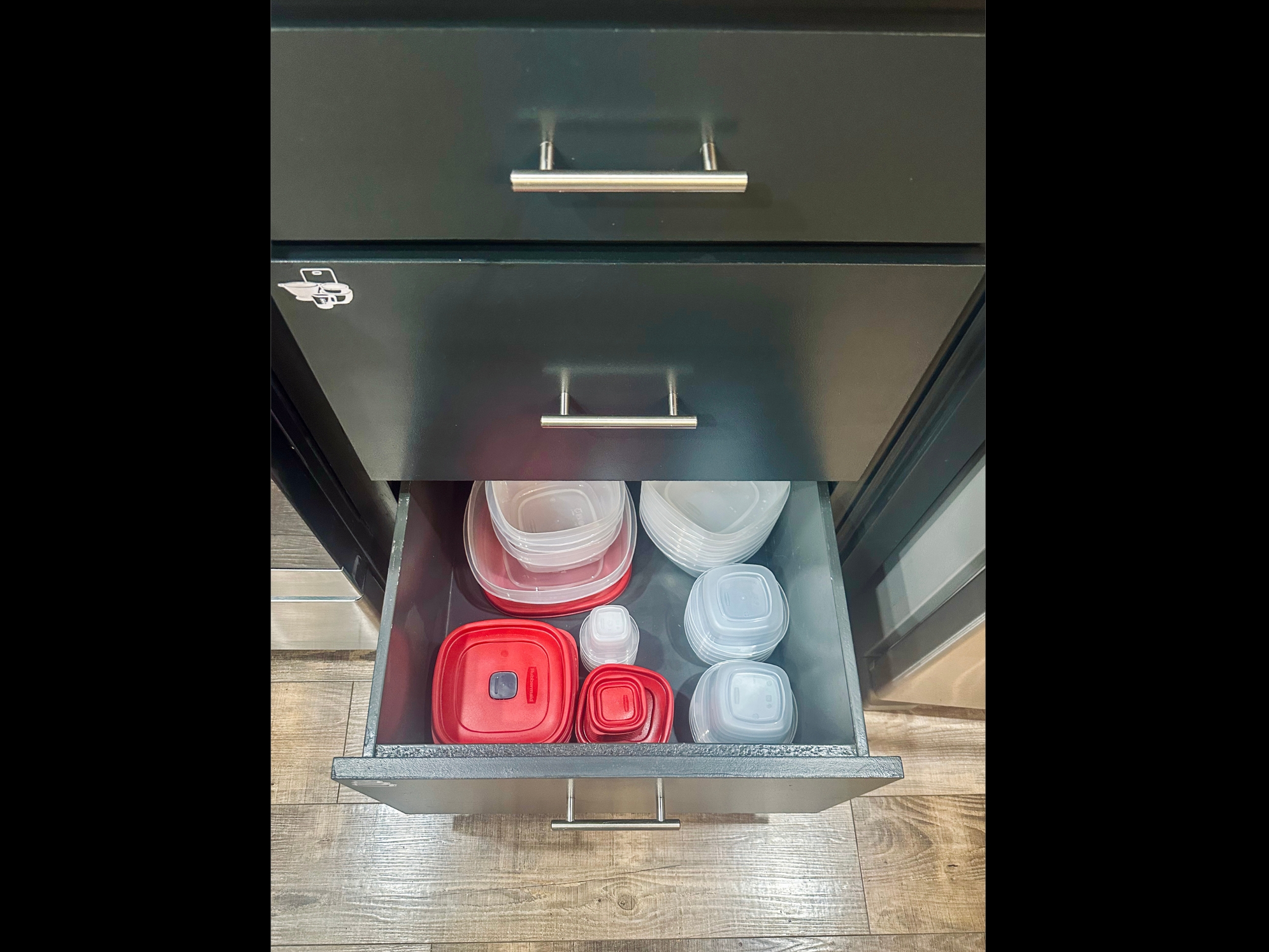 Kitchen drawer organized with a variety of food storage containers to make meal prep and leftovers easy during your stay.
