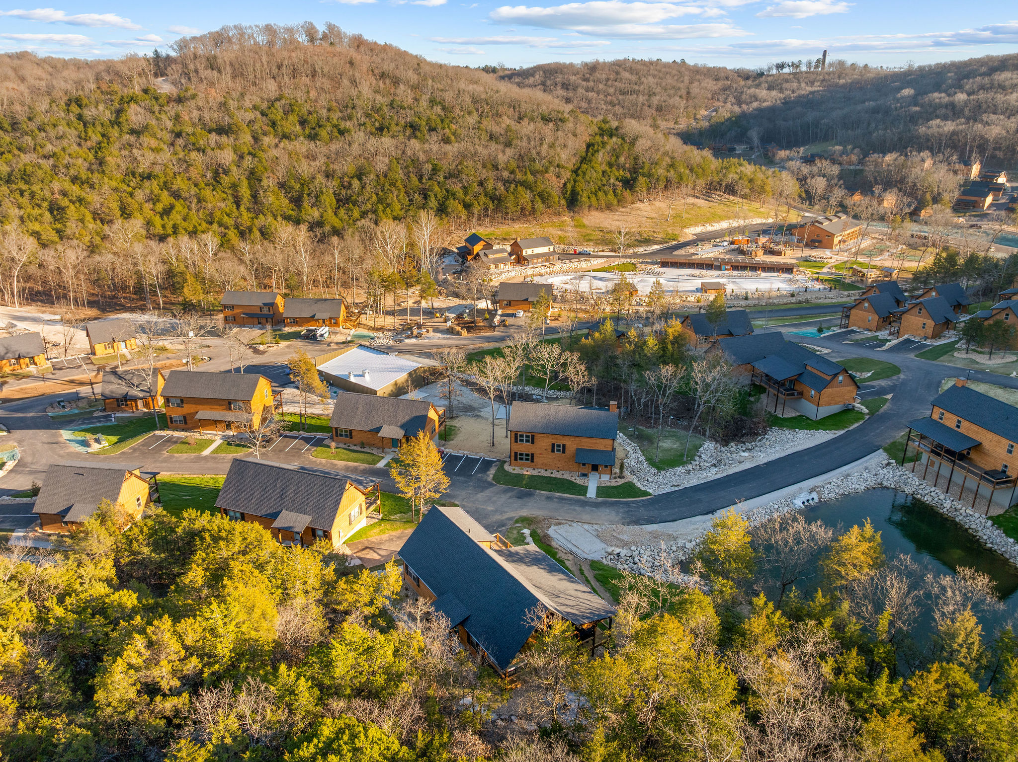 A broader view of the cabin community set among the hills.