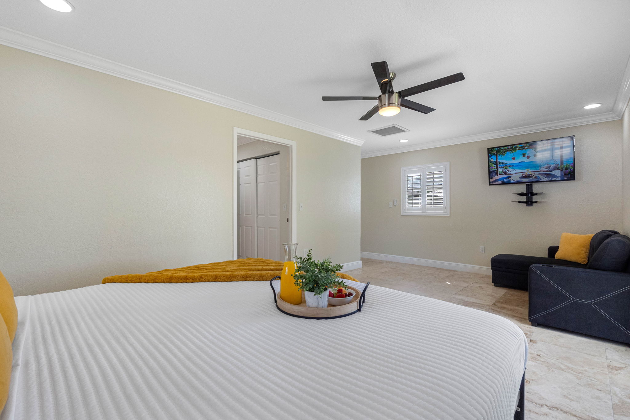 Mustard throw and pillows add warmth to the room’s neutral palette, complementing the stunning view outside.