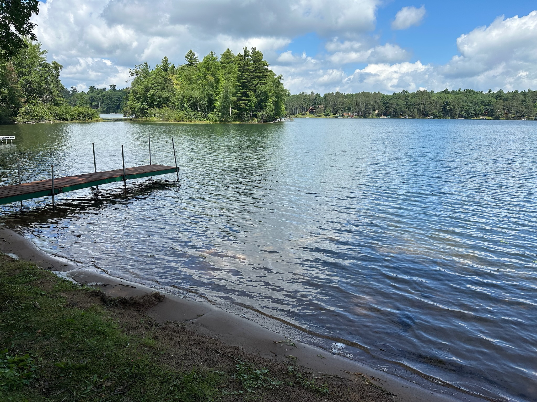 The gentle sandy shoreline is perfect for kids to play or adults to grab a chair and sit with your toes in the water. Bring your boat and park at the private dock.