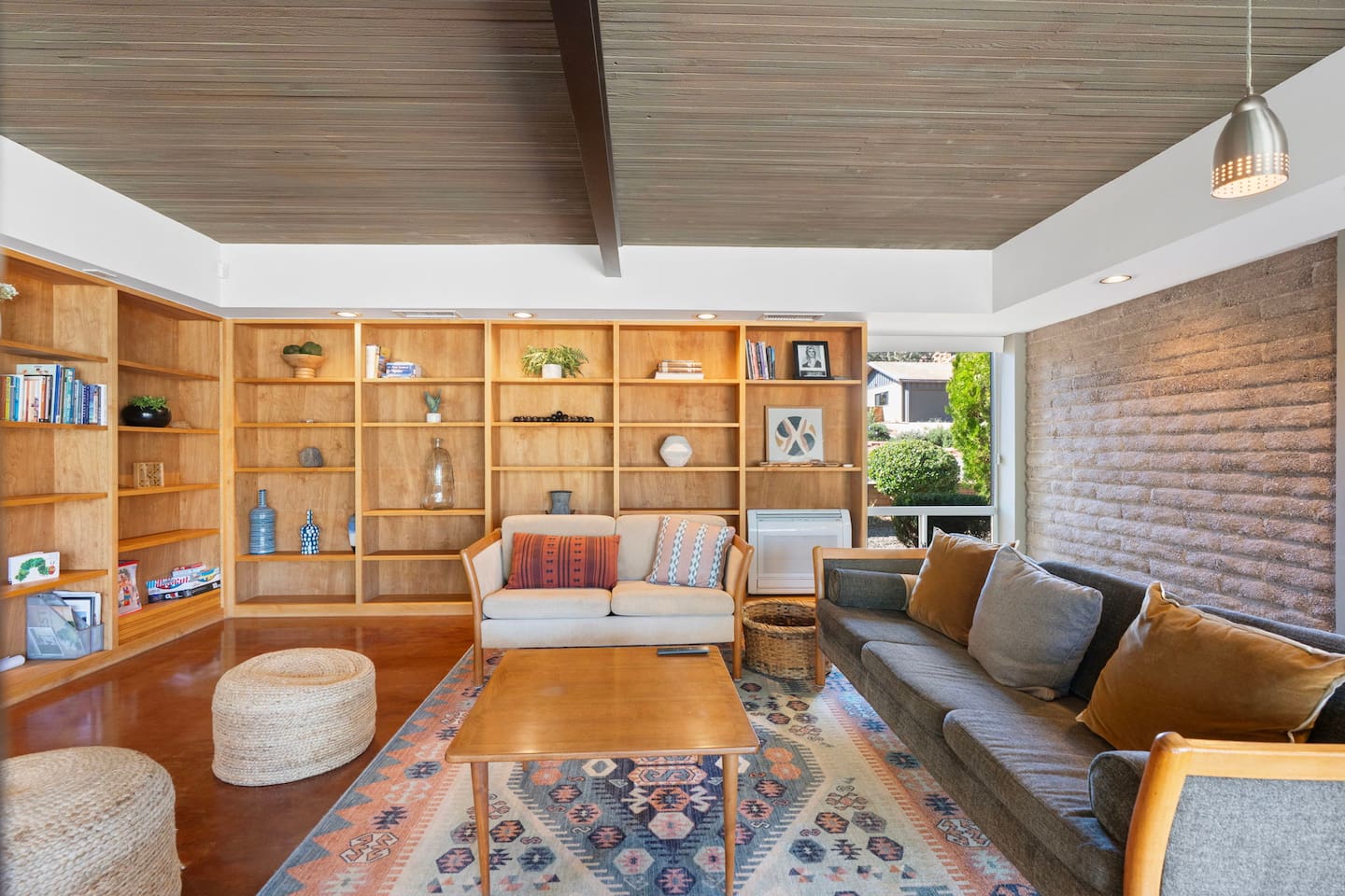 Cozy living room with custom built-ins, warm wood tones, and stylish seating.