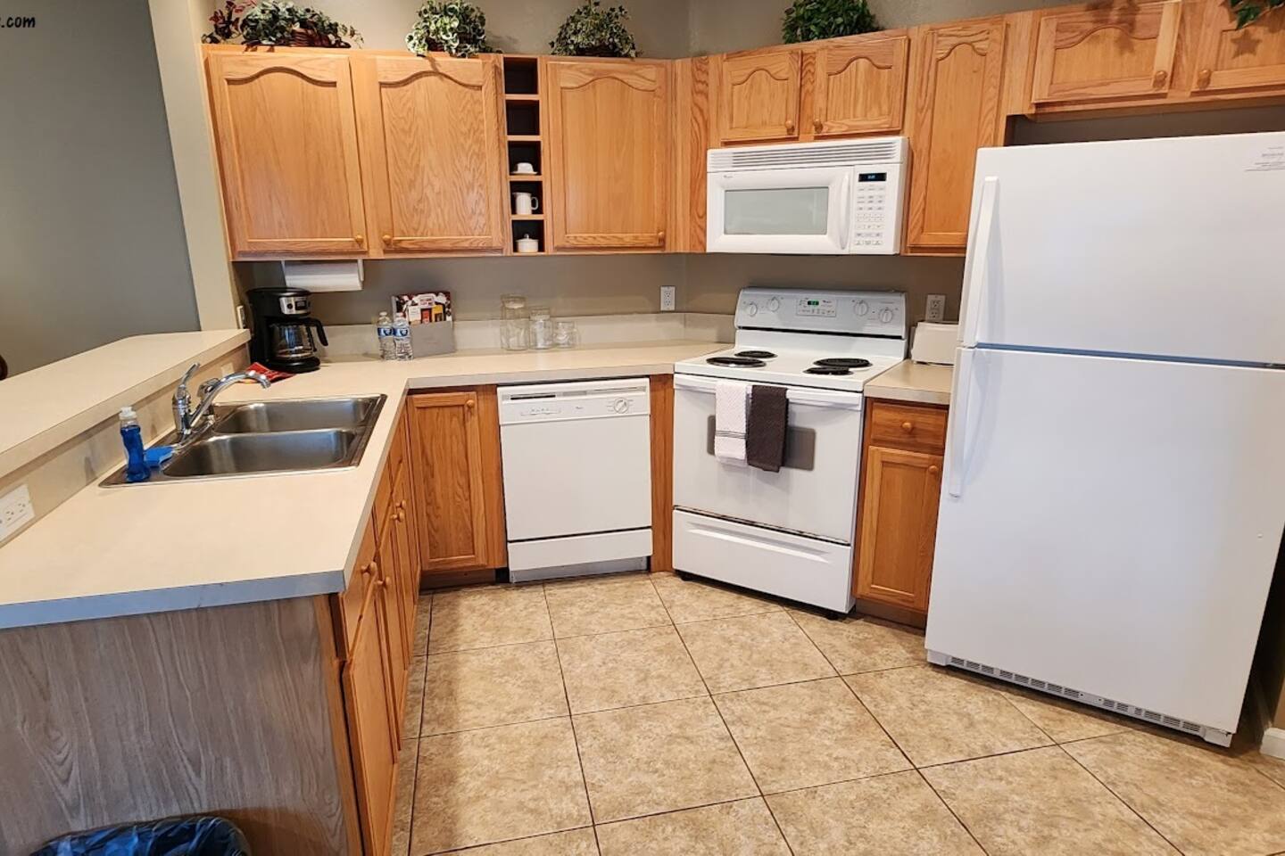 Functional kitchen with full-size appliances, plenty of cabinet storage, and a convenient breakfast bar.