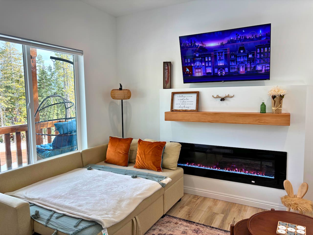 Cozy up by the fire — our sofa unfolds into a full-size bed with forest views