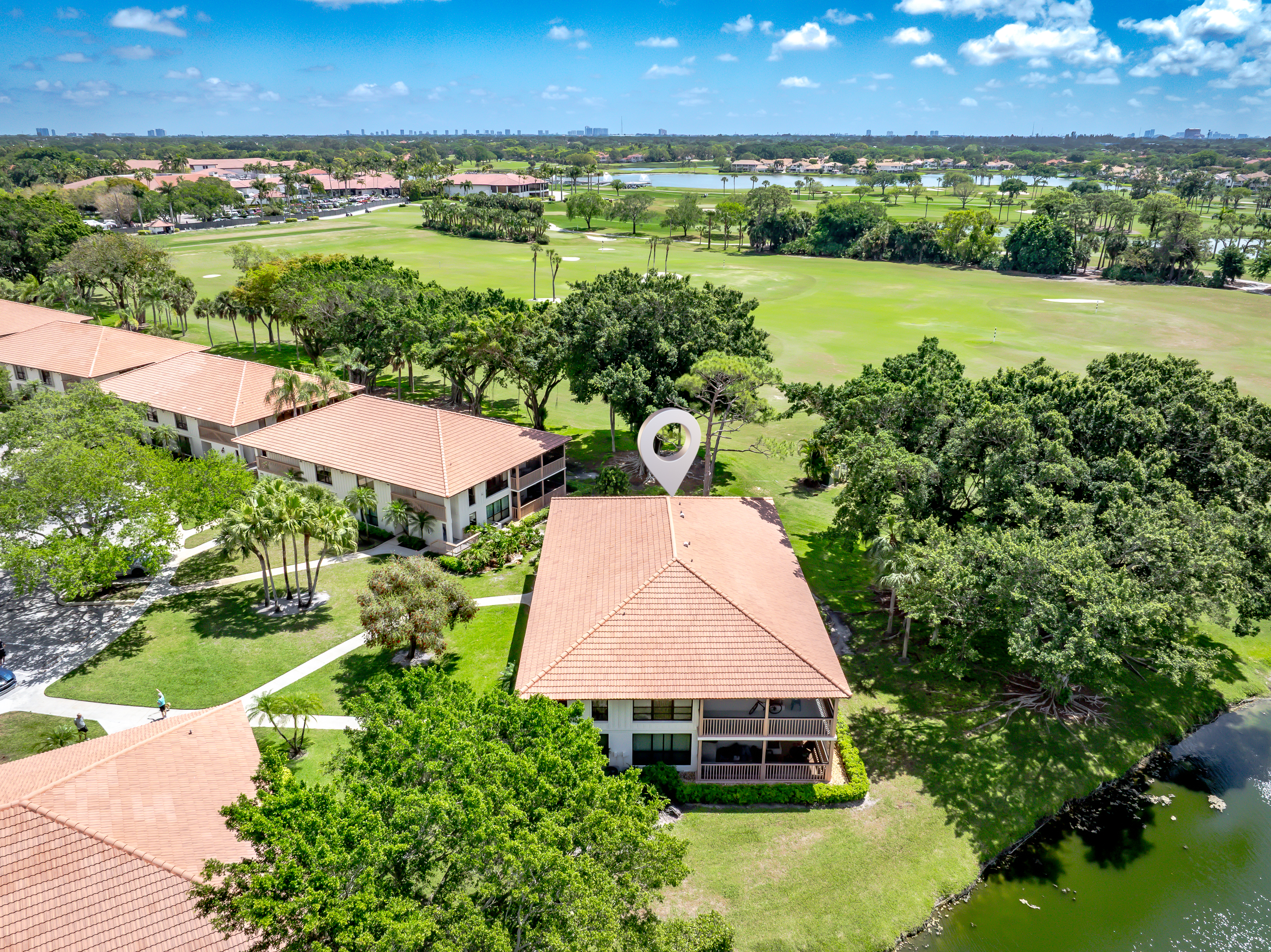 Aerial view showcasing lush golf course, water features, and serene surroundings
