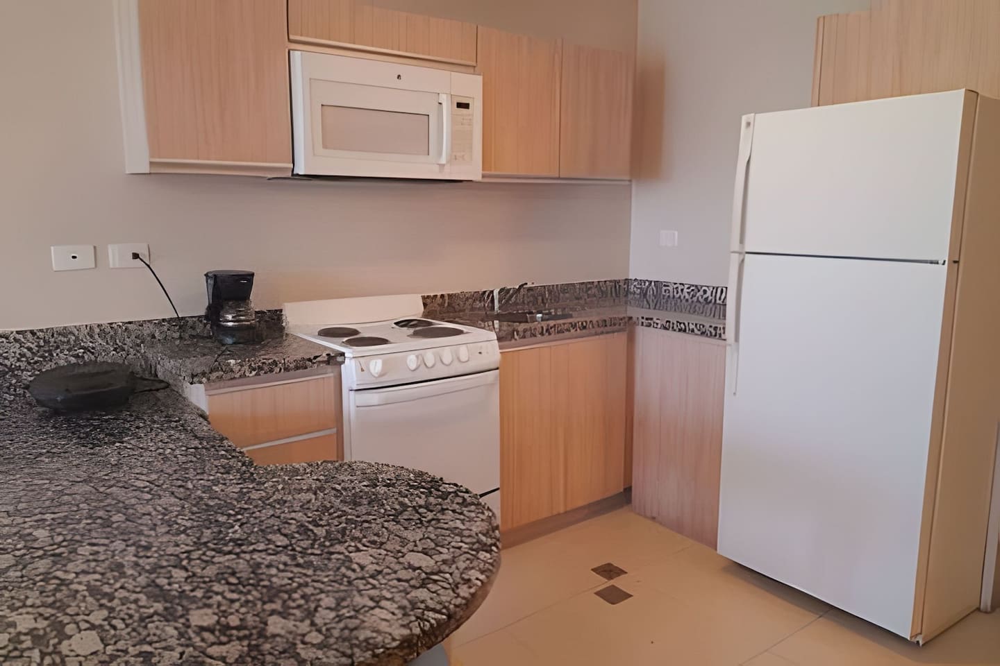 Enjoy preparing meals in our kitchen, designed for both functionality and comfort.