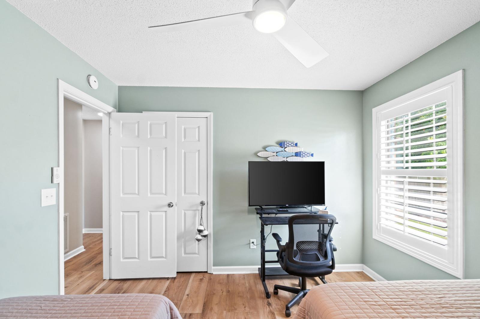 Third bedroom with two beds and workspace