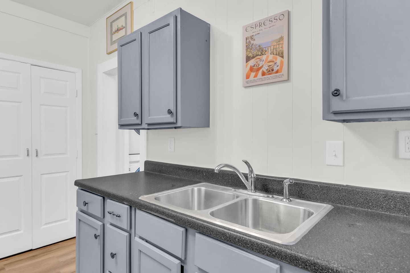 Long kitchen counter with double sink and ample prep space.