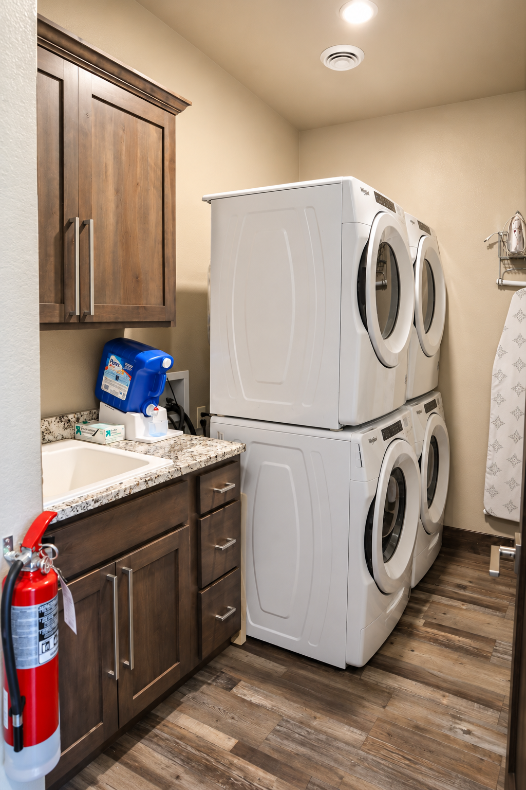 Laundry room with double stacked washers and dryers.