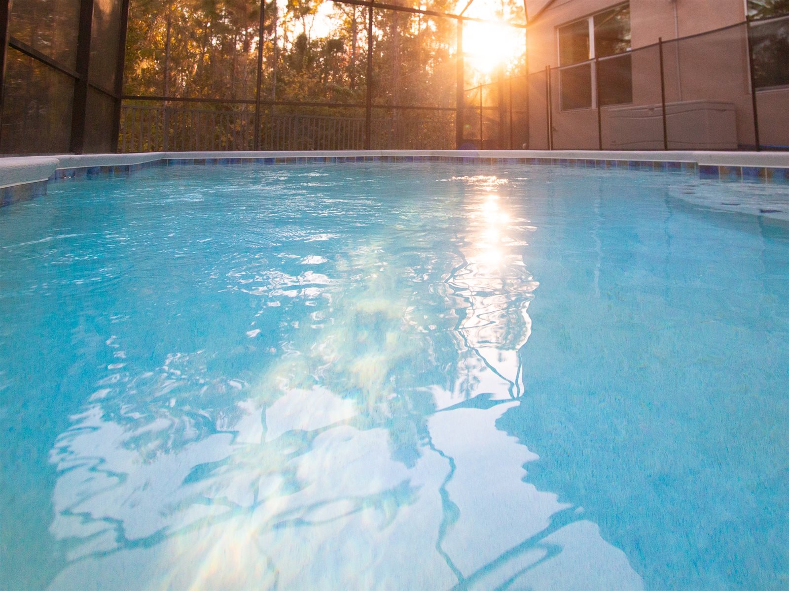 Watch the sun set behind the trees from your Private Screened Pool.