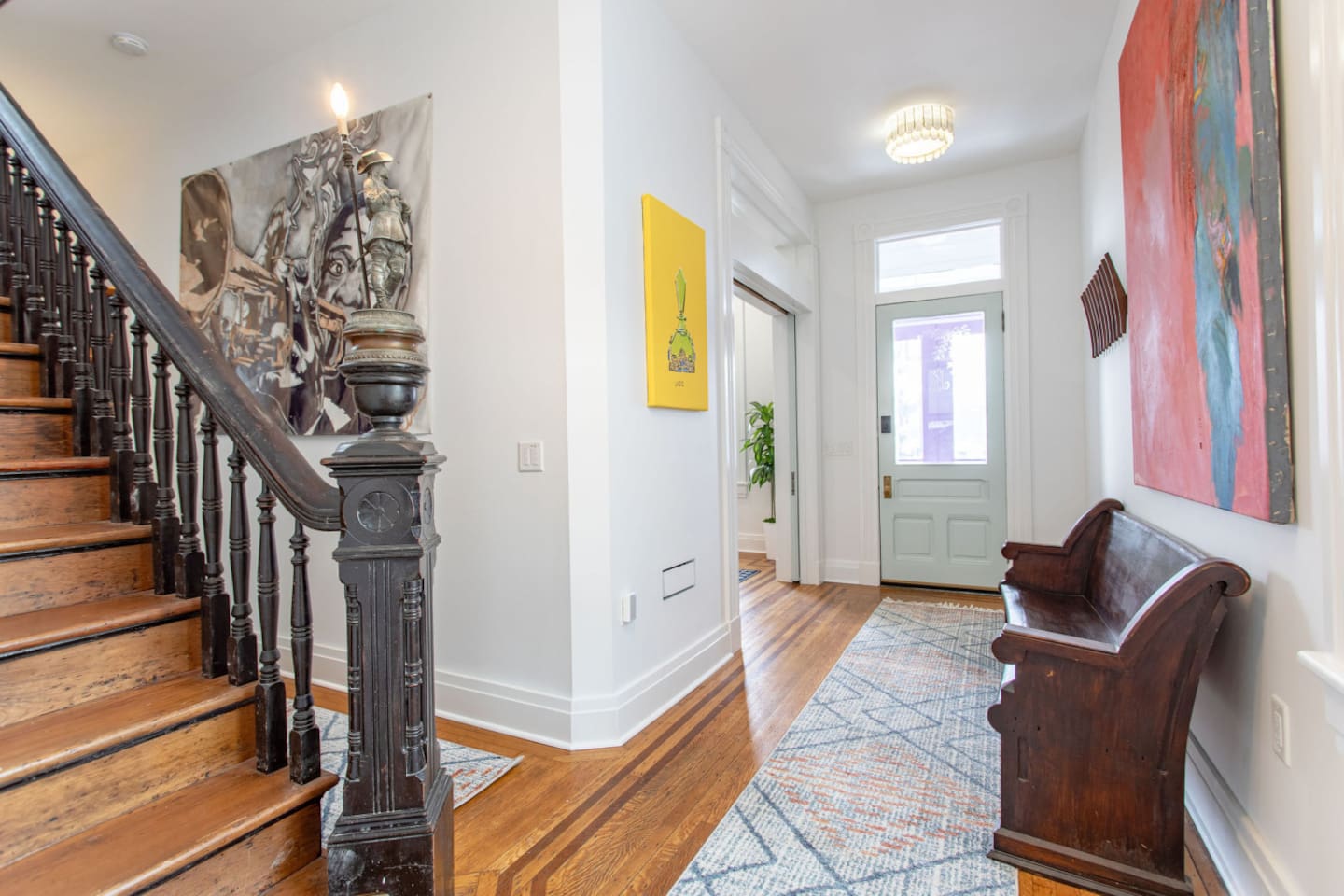 Stairs leading upstairs with a clear view of the entrance door below, offering a spacious, open feel and a welcoming perspective as you ascend.