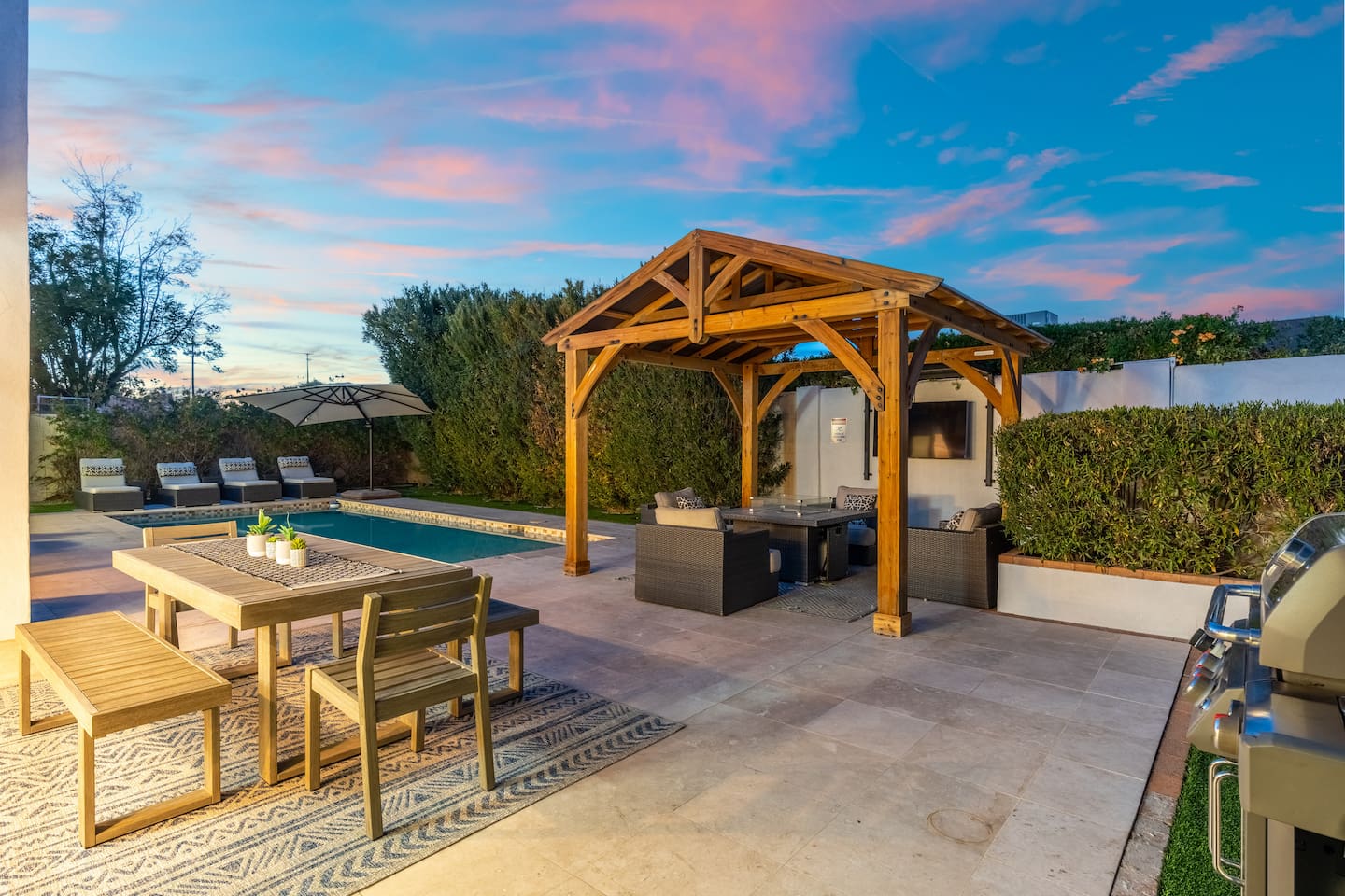The entire backyard transforms at dusk into a magical retreat with inviting textures, colors, and cozy seating arrangements.

