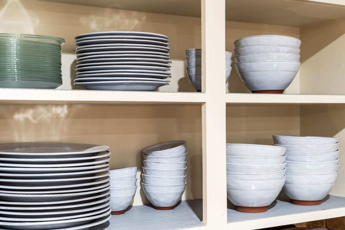 Fully stocked kitchen with modern dishware for large groups — everything you need for family-style meals or casual bites at home.