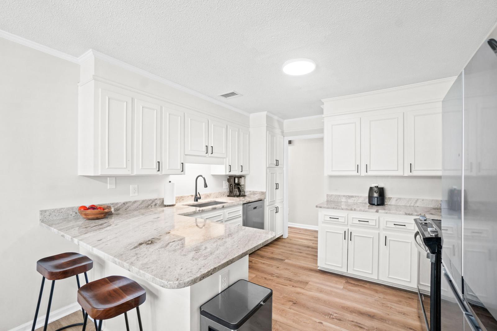 Kitchen with bar seating and all appliances