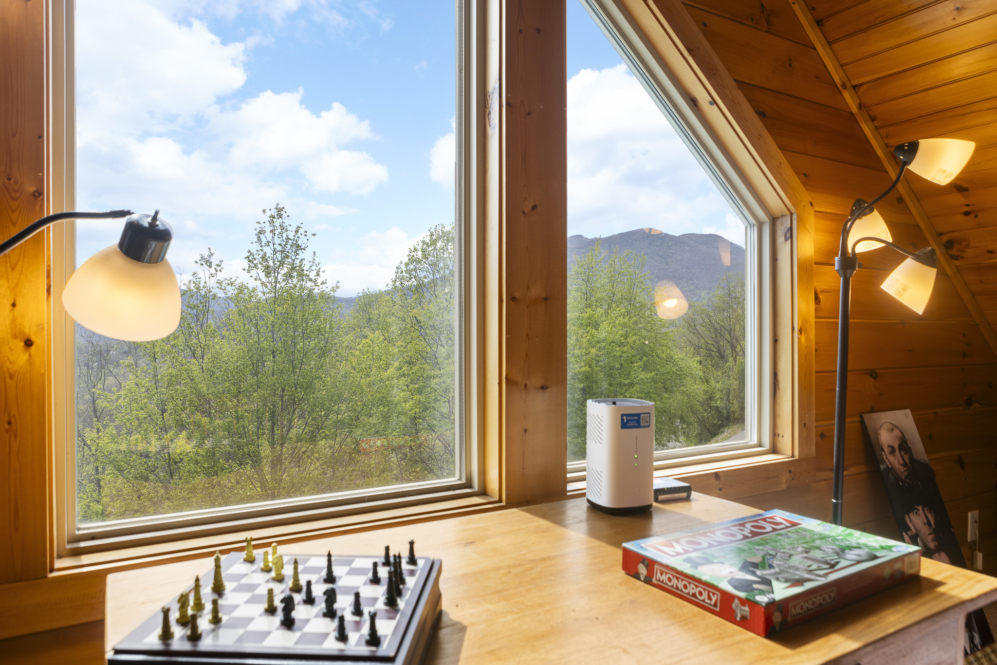 Scenic Retreat: Enjoy mountain views with games and natural light in this charming space!