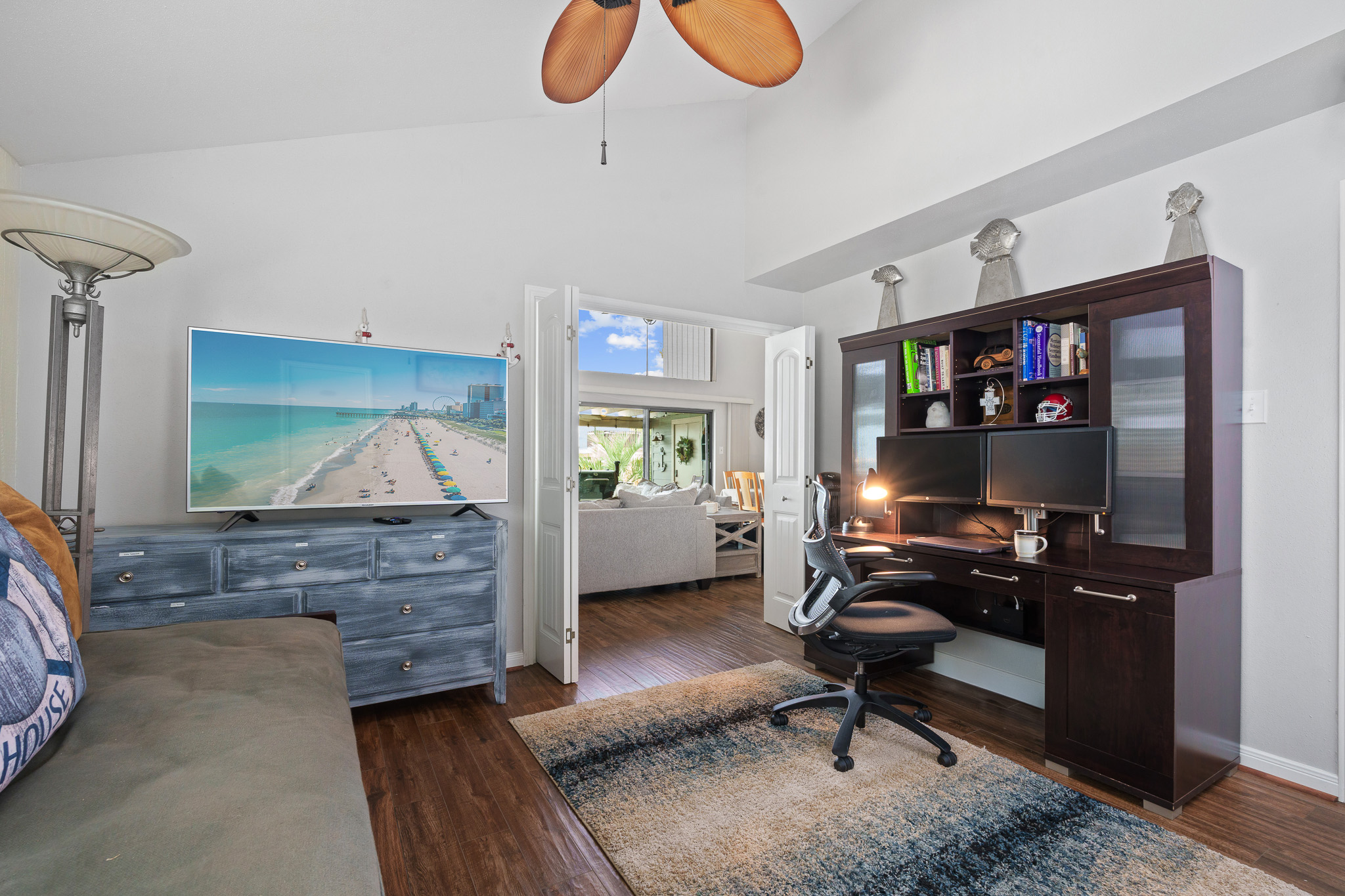This private office retreat features a dual-monitor workstation, day bed area with Roku Smart TV, and serene views into the living room and beyond. Whether you’re working remotely or just catching a show, comfort and productivity go hand in hand.