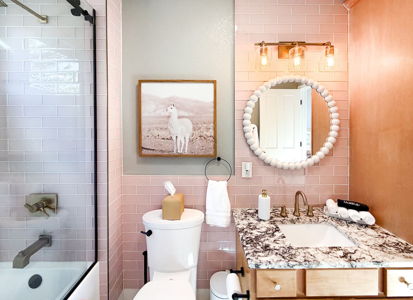 This custom-made bathroom is bright, cheerful, and inviting, featuring a tub, shower, fluffy towels, and gentle soaps. Thoughtful details make it both functional and charming for all ages.